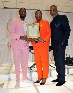 Public Advocate Jumaane Williams, left, presents proclamation to Trinidad and Tobago Opposition Leader Pennelope Beckles-Robinson, flanked by former Grenada Amb. Eugene Pursoo.