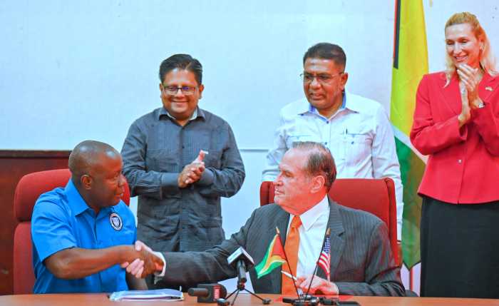 Timothy Innis, acting CEO, National Drainage and Irrigation Authority shakes the hand of Chairman of Blumberg Grain, Phillip Blumberg, after signing a Memorandum of Understanding, as Minister of Finance Ashni Singh, Minister of Agriculture Zulfikar Mustapha, and US Ambassador to Guyana Nicole Theriot, look on. The hub will be established at Yarrowkabra, on the Soesdyke-Linden Highway.