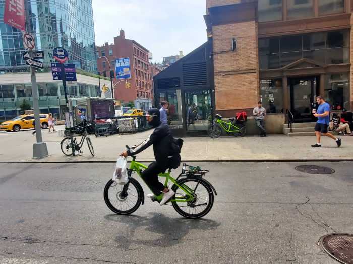 A deliverista at work on an e-bike in Greenwich Village on July 22, 2024.