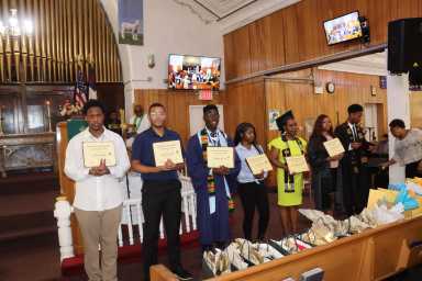 Graduates display their certificates.