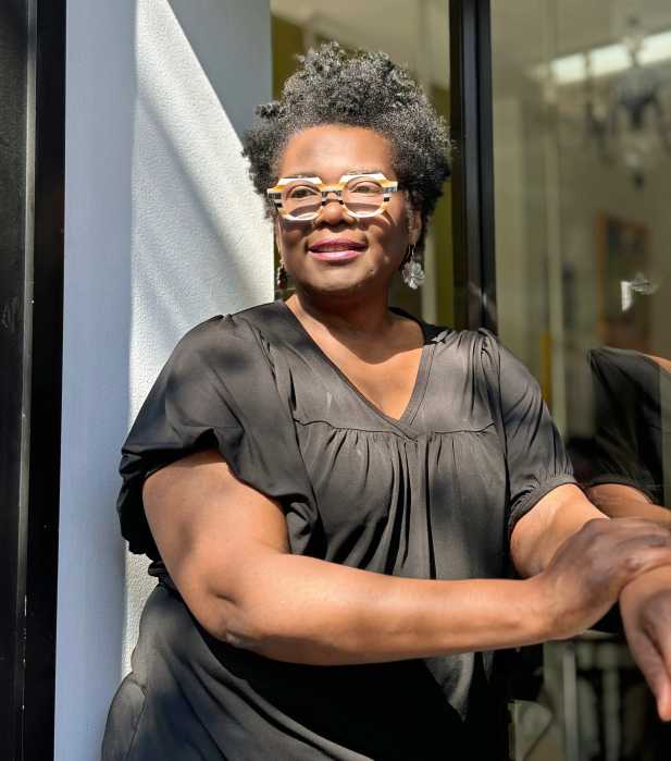Carol Thomas stands outside Just Because Salon in Fort Greene, Brooklyn, which she has transformed into a sanctuary for women living in shelters and facing difficult life transitions.