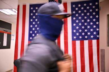 A masked ICE agent in 26 Federal Plaza on July 22, 2025.