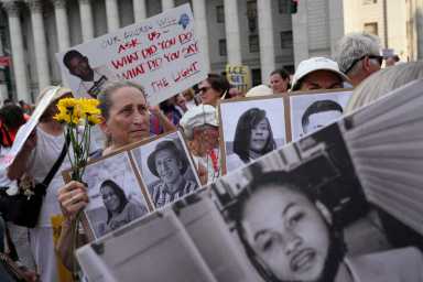 People hold signs with the pictures of missing people during a "Good Trouble Lives On" protest against U.S. President Donald Trump and in remembrance of late U.S. Congressman and civil rights pioneer John Lewis, in New York City, U.S., July 17, 2025.