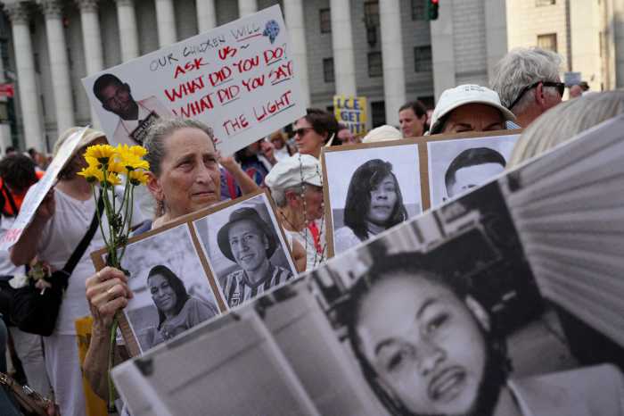 People hold signs with the pictures of missing people during a "Good Trouble Lives On" protest against U.S. President Donald Trump and in remembrance of late U.S. Congressman and civil rights pioneer John Lewis, in New York City, U.S., July 17, 2025.