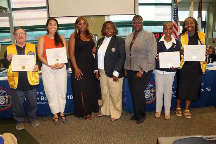 Council Member Farah N. Louis, third from left, Sen. Roxanne Persaud, fifth from left, and Jean Joseph, fourth from left, stood with honorees after Louis and Persaud bestowed citations on club members.