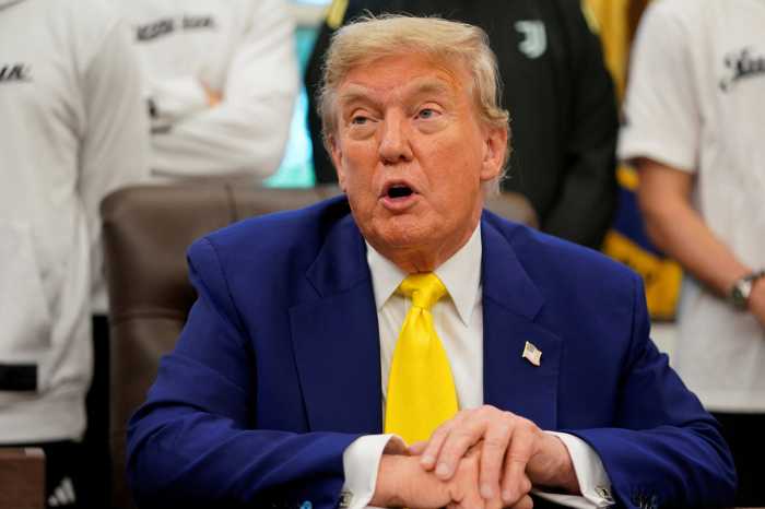 U.S. President Donald Trump speaks with the media accompanied by players of the Juventus soccer team, in the Oval Office of the White House in Washington, D.C., U.S., June 18, 2025.