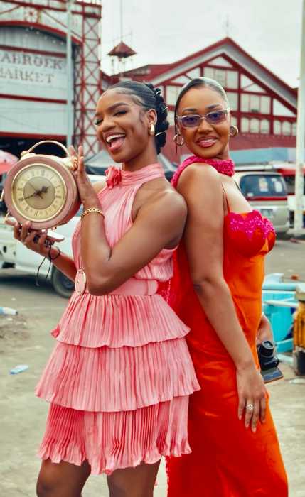 Two young travelers pose for a photo in front of Stabroek Market, one of Georgetown’s most iconic landmarks.