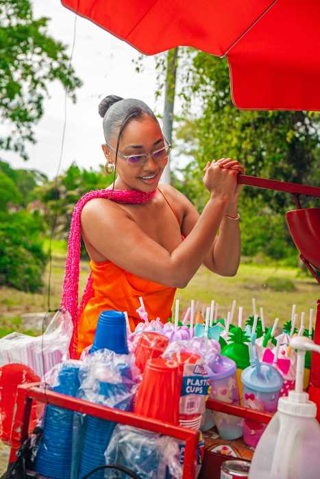 A traveler enjoys a hands-on activity, making her snow cone during the city and culinary tour.