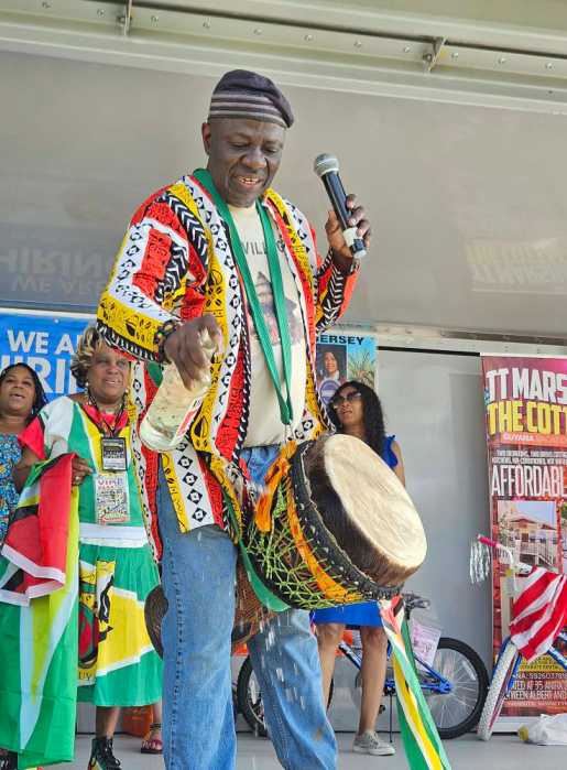 African drummer Carlye Fraser pours a libation during the Guyana Fun Day.