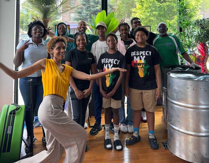 Jeanine Ruiz, musical director in front with yellow top, Joshua Regrello Guinness record holder in the middle of back row, Keith Marchelle Tropicalfete board member with green jersey on the right and the rest of Tropicalfete SteelPan Ensemble.