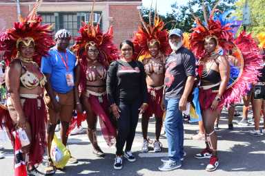 Edwin Worrell, second from left, Derek Noel, second from right, with masqueraders in Deck Productions, Branches and Associates and Mango Tree Productions' "A Touch of Class" in WIADCA Carnival Parade 2024.