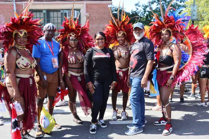 Edwin Worrell, second from left, Derek Noel, second from right, with masqueraders in Deck Productions, Branches and Associates and Mango Tree Productions' "A Touch of Class" in WIADCA Carnival Parade 2024.
