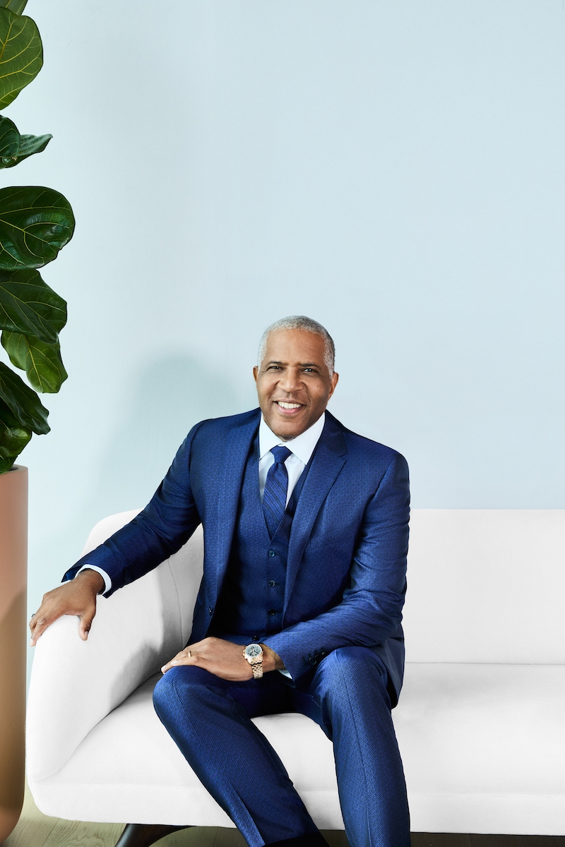 author of Lead Boldly man in suit sitting on couch