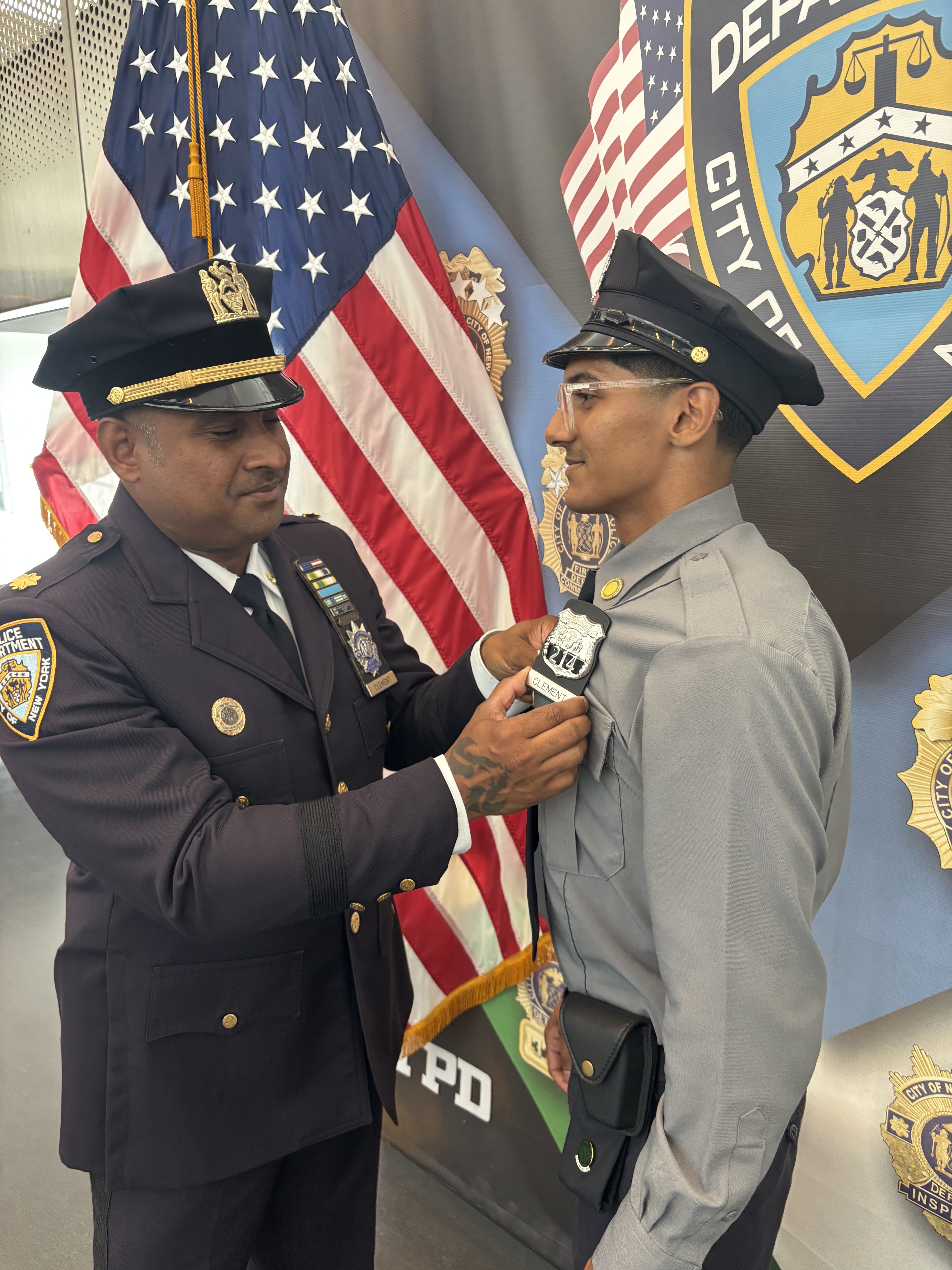Deputy Inspector Ralph Clement places his son Daniel’s badge, a symbolic passing of the torch in a multi-generational law enforcement family.