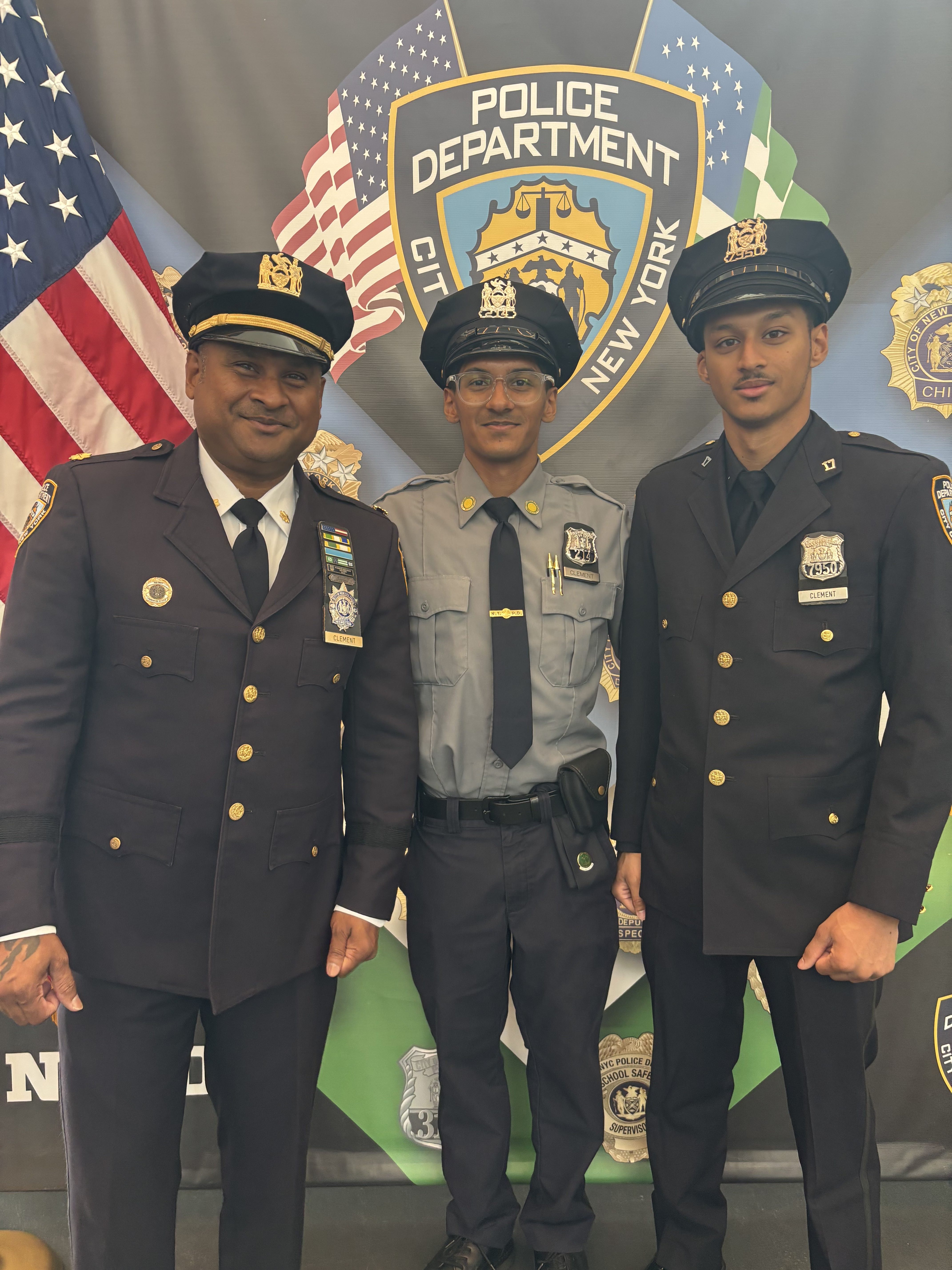 A moment of pride and unity as Daniel Clement shares a celebratory embrace with his father and older brother, both fellow NYPD officers, after completing rigorous academy training.