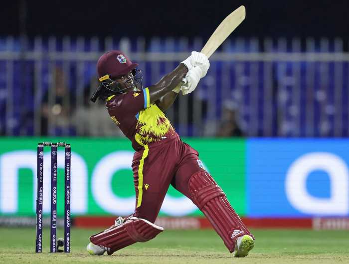 A Cricket West Indies player competing, swinging bat