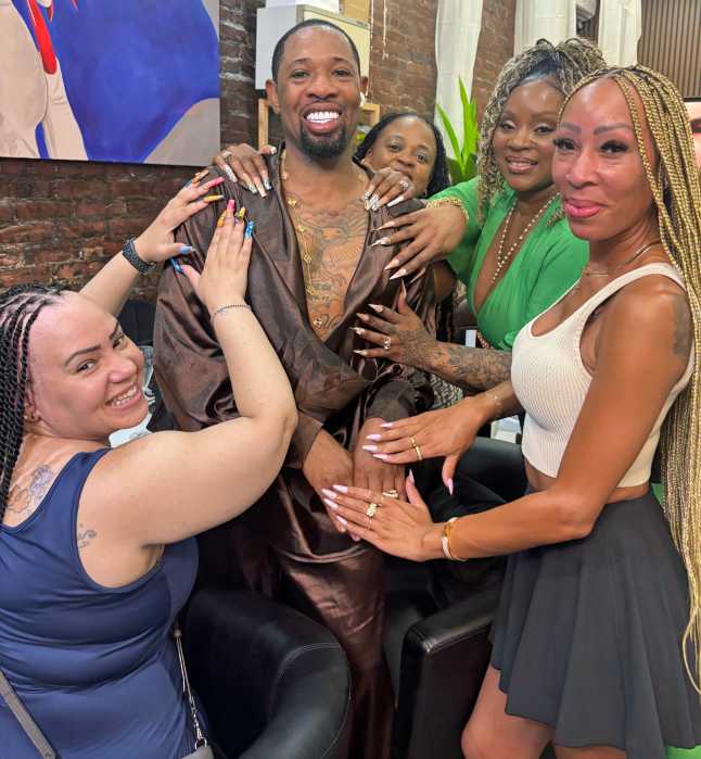 Owner Barrington “Barry” Blye shares a moment with loyal clients at the grand relaunch of his beauty Bar, now welcoming guests at 1429 Flatbush Ave. in Brooklyn.