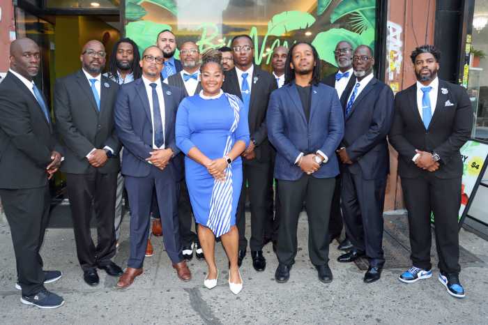 Rebekah Severe, center, sister of the late Dr. Luc Severe, flanked by members of Brooklyn Sigmas.