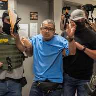A migrant is detained by federal immigration officers at U.S. immigration court in Manhattan, in New York City, U.S., July 23, 2025.