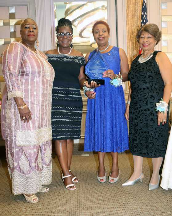 Registered Nurse Claudette Powell, CANA PRO, third from left, presents Leadership Award to Guyanese-born Registered Nurse Dr. Launette Woolforde, second from left, flanked by incumbent CANA President Registered Nurse Barbara Osborne, left, and Mistress of Ceremonies Dr. Jean Leon, right.
