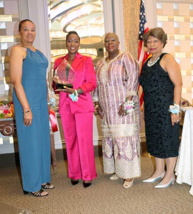 Gail Haynes, second from left, receives Leadership Award on behalf of Registered Nurse Dr. Natalia Cineas, flanked by, left to right: Registered Nurse Helene Cauvin, who read Dr. Cineas's bio; CANA President Registered Nurse Barbara Osborne; and Mistress of Ceremonies Dr. Jean Leon.