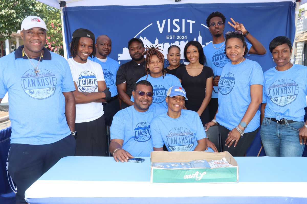 Calvin Sennon and wife, Latoya, seated, with staffers and volunteers at Mas in Canarsie launch on Saturday, Aug. 2, 2025.
