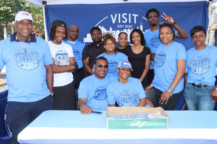 Calvin Sennon and wife, Latoya, seated, with staffers and volunteers at Mas in Canarsie launch on Saturday, Aug. 2, 2025.