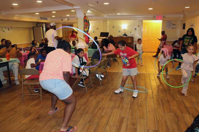 Children play with the hula hoop during Annual Back-to-School event organized by the Family Life Committee of Fenimore Street United Methodist Church (FSUMC) in Brooklyn on Aug. 2, 2025 .
