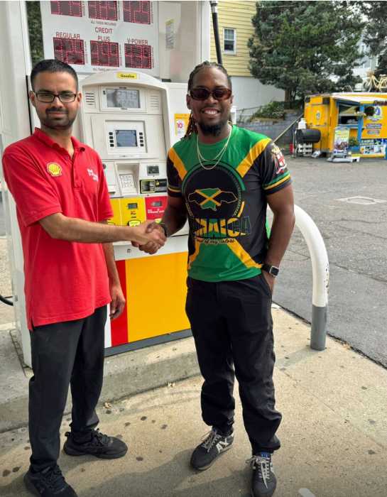 Rutwik Reddy of Shell and the Reggae Goose owner Jerry McDonald, right, share lens time.