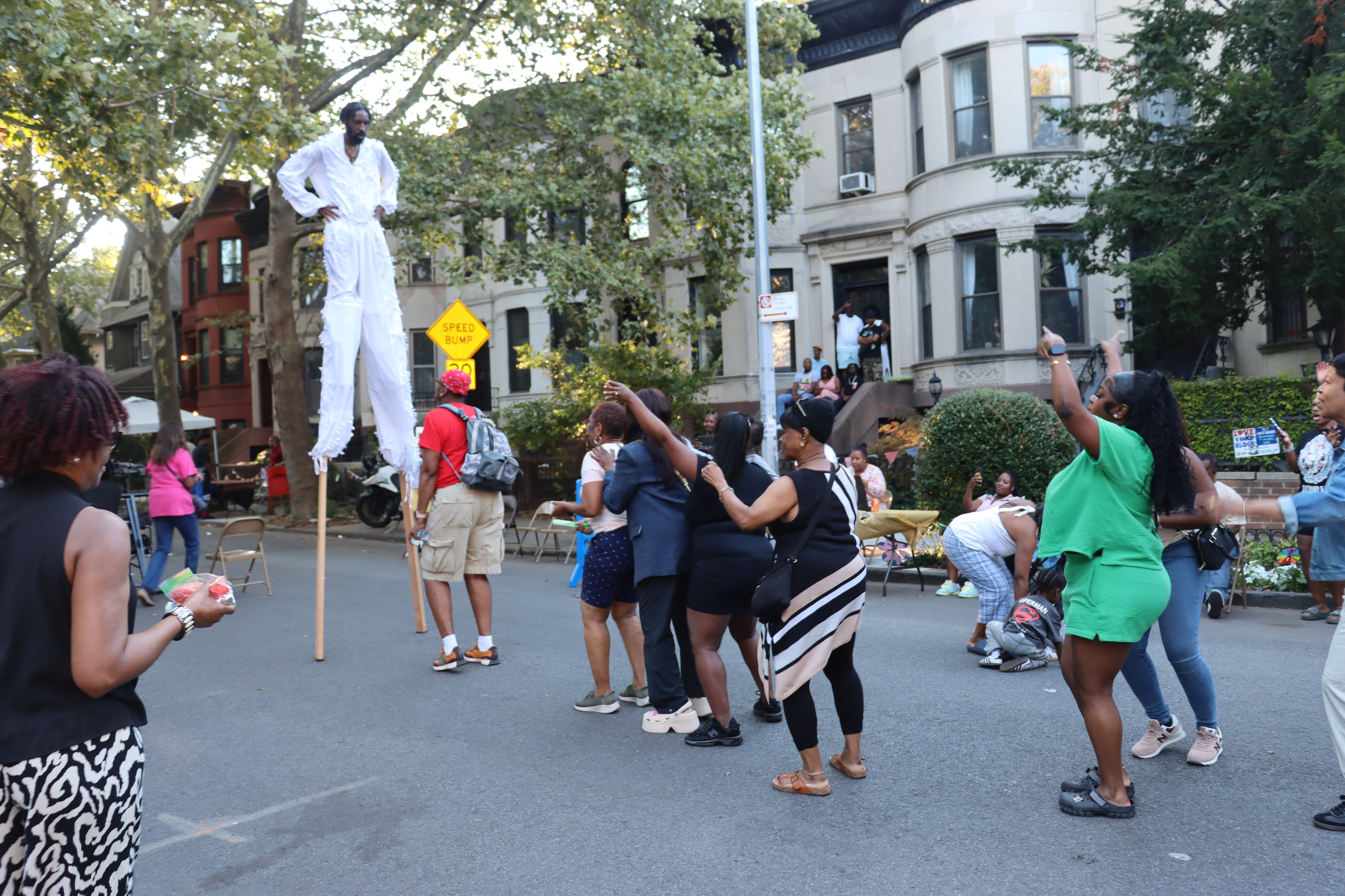 Forming a Conga Line to dance with the Stilt Dancer