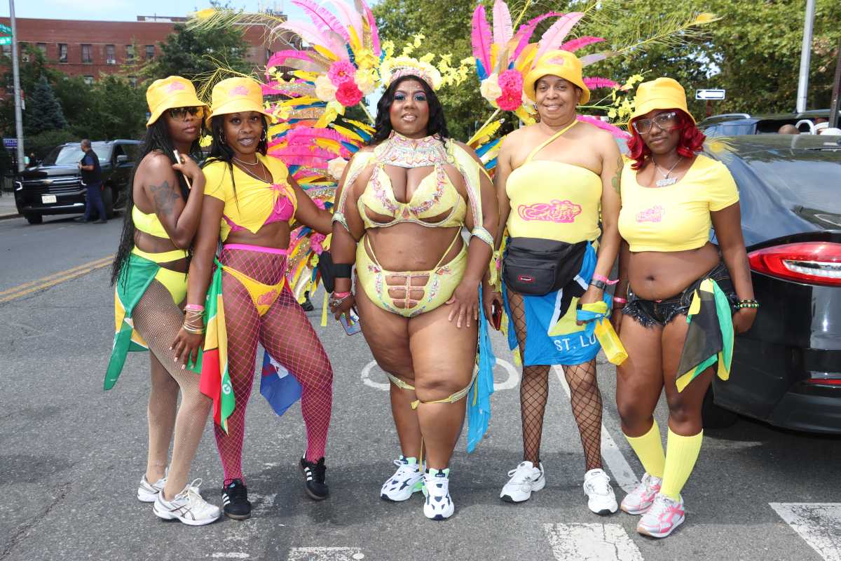 Felicia England, center, portrays Suga Candy Mas' "Forsithia", flanked by other Suga Candy masqueraders