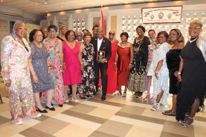TTNAA nurses flank Consul General Andre Laveau, center, who holds a plaque.