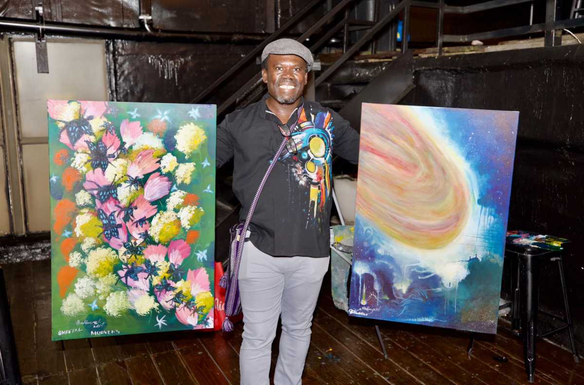 Artist Vladimir Walter who was honored, pictured with his works.