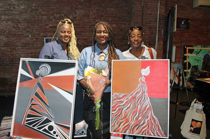 Brooklyn artist Tara center, surrounded by family members at her art series honoring women, during a display at a Sept. 13 Black Art Matters Pop-Up tour at Waverly Street art space in Brooklyn.