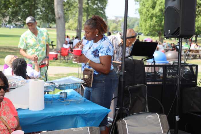 A guest samples a popular West Indian drink at the IUOM Annual Family Day Picnic.