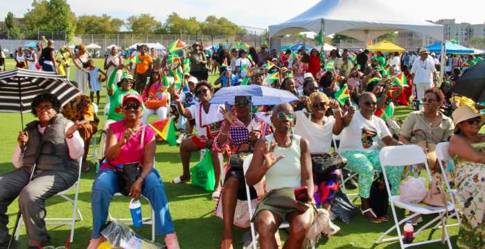 A colorfully dressed crowd waved their flags on the grounds of Old Boys High school in Brooklyn, during GCA's rousing 25th Annual Folk Festival Family Funday celebration.