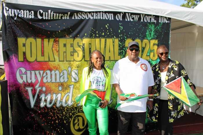Assembly Member Monique Chandler-Waterman, who represents the 58 Assembly in District in Brooklyn, Consul General to New York Michael E. Brothrson and Guyanese-born Senator Roxanne Persaud of the 19th Senate District in Brooklyn pose against the backdrop of GCA Silver Jubilee banner on Old Boys High school in Brooklyn, during GCA's rousing 25th Annual Folk Festival Family Funday celebration on Aug. 31.