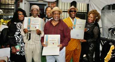 From left, President of the Guyana American Heritage Foundation, and Curator of the Musician Appreciation Awards, Lady Ira Lewis, Bass Guitarist, Drummer Colin Stewart, Lead Guitarist, Richard Schultz, and President of the Guyana American Heritage Foundation, with their Awards. Miss CARICOM, Monica Sanchez, far right, at the Musician Appreciation Awards, at the Waterfall Lounge, on Church Avenue, Brooklyn, on Sept. 14, 2025.