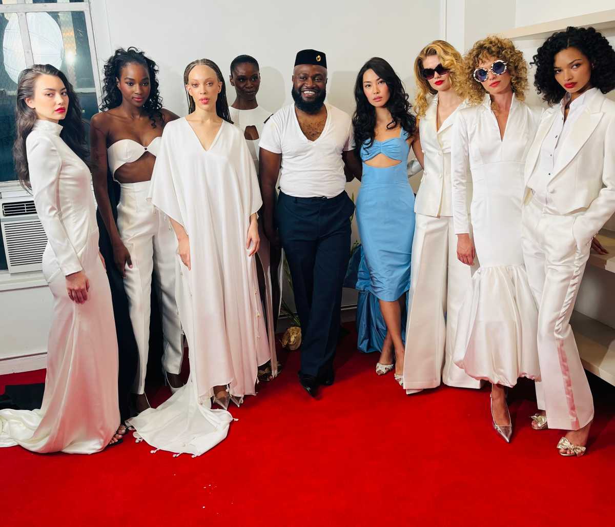 Designer Charles C. Dieujuste (center) with the models wearing the SCORCÉSA brand outfits.