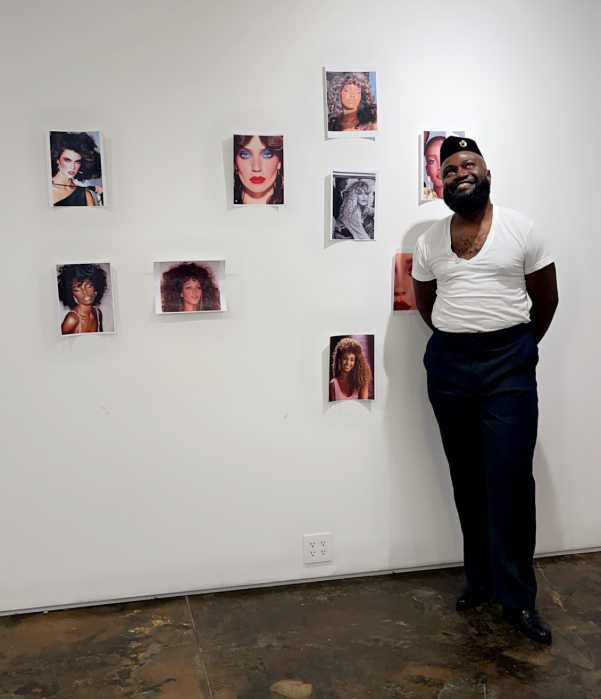 Designer, Charles C. Dieujuste stands in front of his inspirational wall of his collection.