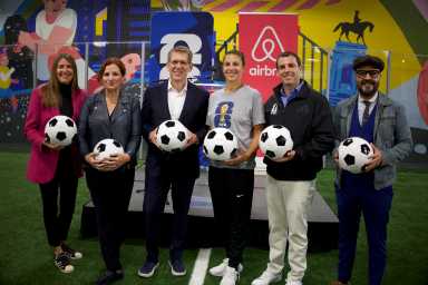Jennifer Arnold, VP of Marketing and Communications at the U.S. Soccer Foundation; Christine Quinn, President and CEO of Women in Need (WIN); Jay Carney, Airbnb Global Head of Policy and Communications; two-time FIFA Women’s World Cup Champion Carli Lloyd; Alex Lasry, CEO of the FIFA World Cup 26 NYNJ Host Committee; and New York City Council Member Francisco Moya gather in Brooklyn to announce new community investments.