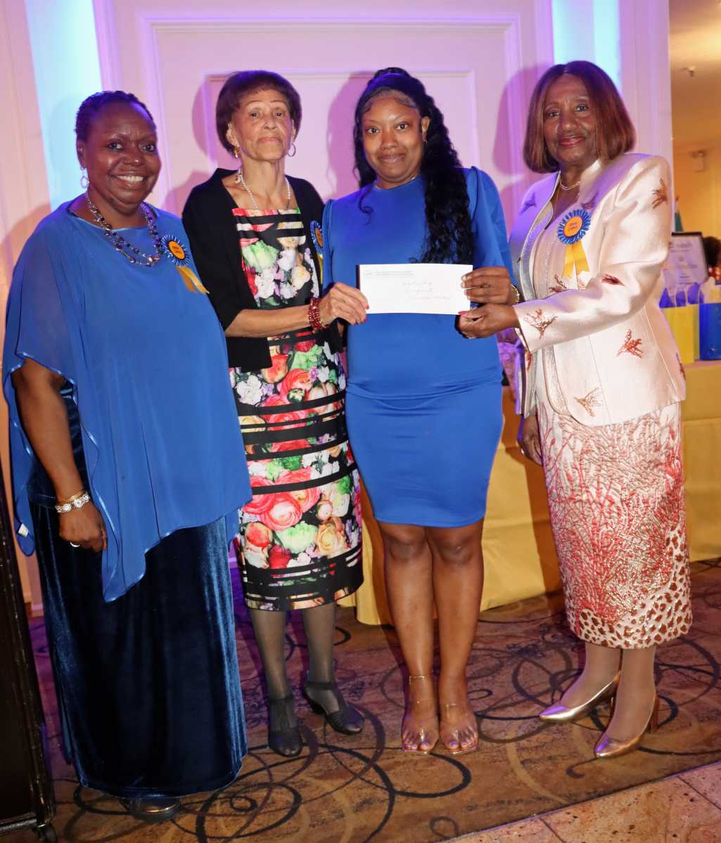 Veronica Weekes, third from left, receives scholarship award, flanked by Dr. Virginia Bernard, RN, president of the Bronx, Manhattan and Westchester Chapter of the Caribbean American Nurses’ Association, Inc. (CANA), right; Mistress of Ceremonies Wendy Lake-Ricke, RN, left; and Lorna Ferriera, RN.