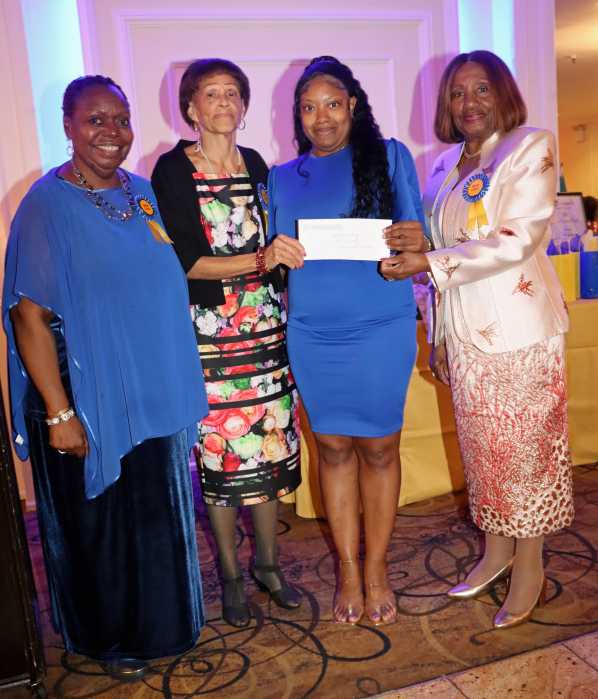 Veronica Weekes, third from left, receives scholarship award, flanked by Dr. Virginia Bernard, RN, president of the Bronx, Manhattan and Westchester Chapter of the Caribbean American Nurses’ Association, Inc. (CANA), right; Mistress of Ceremonies Wendy Lake-Ricke, RN, left; and Lorna Ferriera, RN.