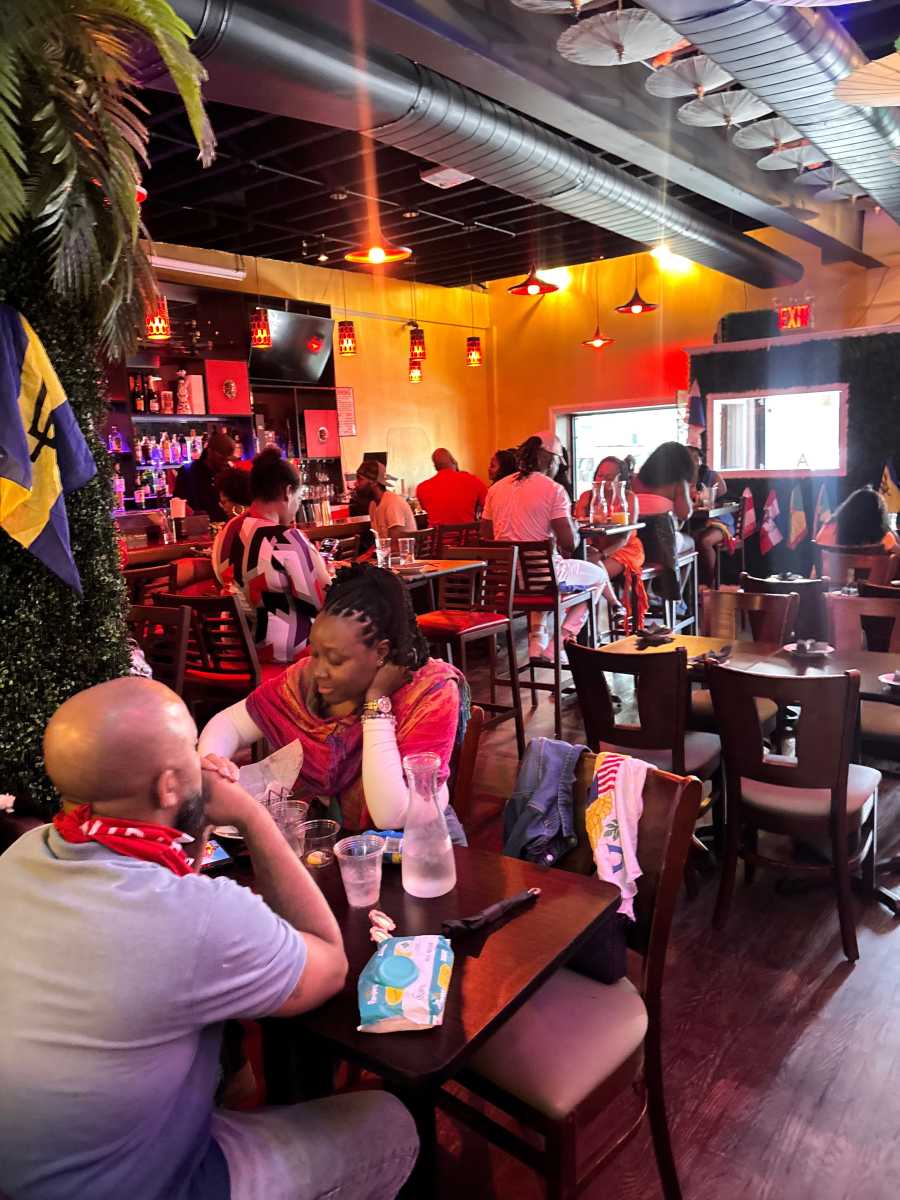 Patrons enjoy brunch at CZEN Restaurant in Brooklyn, where the menu fuses Caribbean classics like jerk chicken with Asian-inspired dishes.
