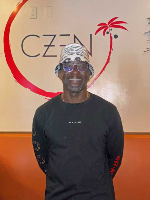 Co-owner Netfa Ricketts stands inside CZEN Restaurant in Brooklyn. Ricketts says the name stands for “Caribbean Zen” and reflects the team’s vision to blend their cultural roots with Asian flavors.