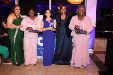 Breast cancer survivors receive an award, with CABS' CEO Sherly Demosthenes-Atkinson, fourth from left, and CABS' staff member Lanicia Francis, left.