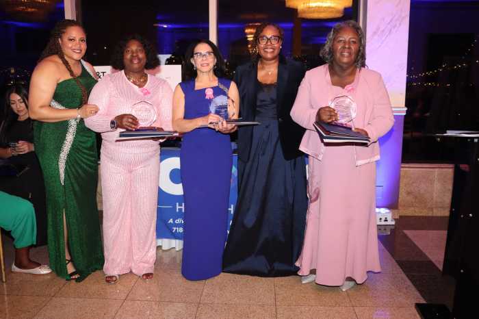Breast cancer survivors receive an award, with CABS' CEO Sherly Demosthenes-Atkinson, fourth from left, and CABS' staff member Lanicia Francis, left.