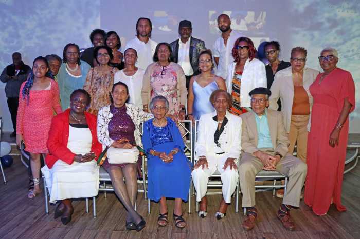 Gloria Lewis, seated third from left, front row, with extended family members.