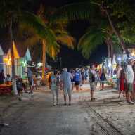 People walking and enjoying the shopping at vendors that are set up on a Friday night at Oistins in Barbados.