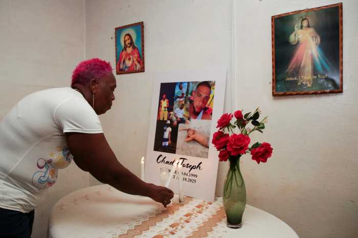 Lynette Burnley, aunt of Chad Joseph, who family members believe was killed in a U.S. military strike on a boat in the Caribbean, lights a candle at an altar for Joseph in the family home in Las Cuevas, Trinidad and Tobago, Oct. 22, 2025.